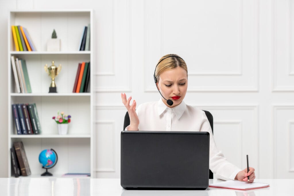 customer service cute woman white shirt with headset computer taking down notes confused